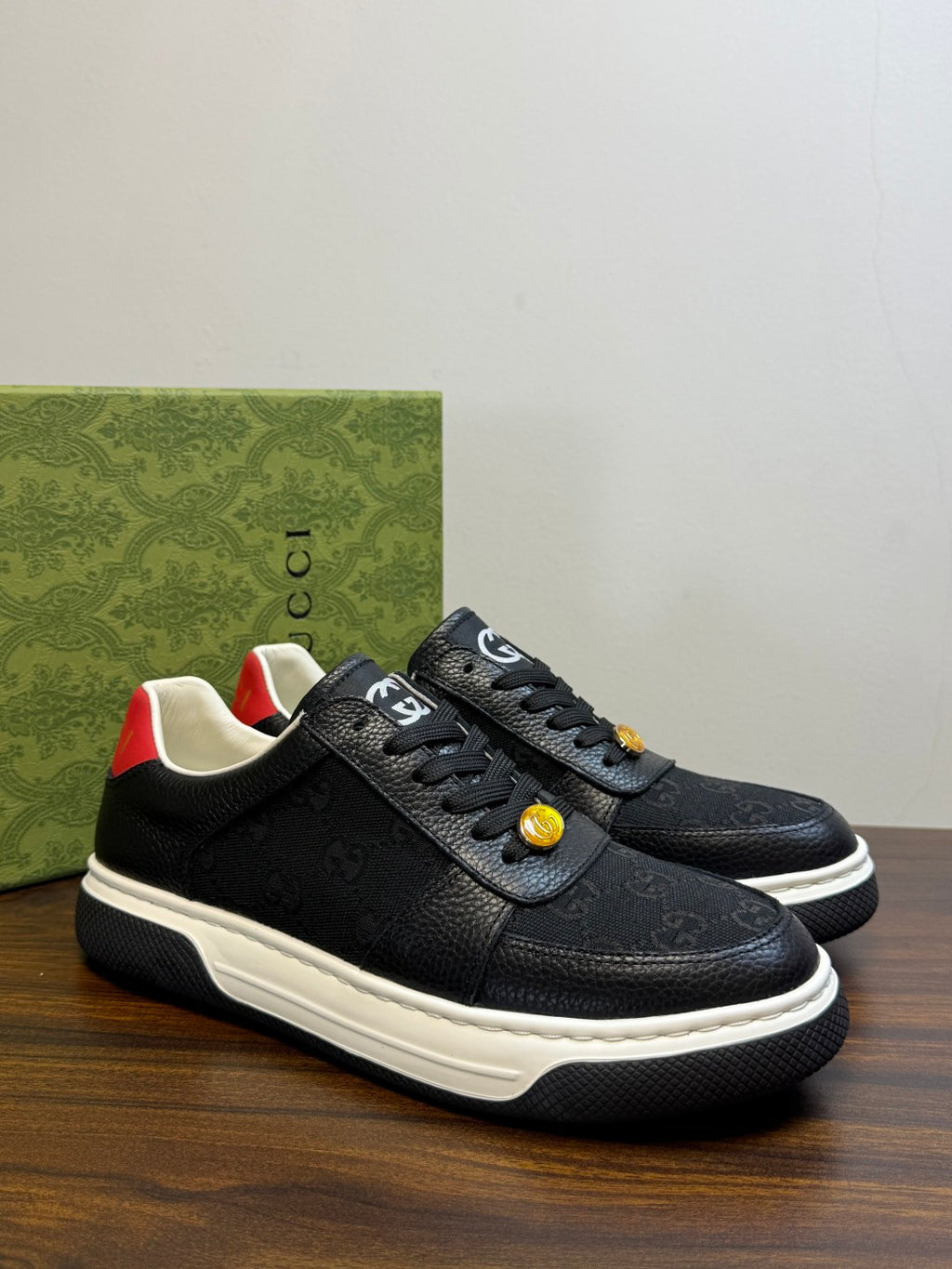 Gucci Ace Black GG Supreme Sneakers | Understated Style, Gold-Tone Accents & a Pop of Red