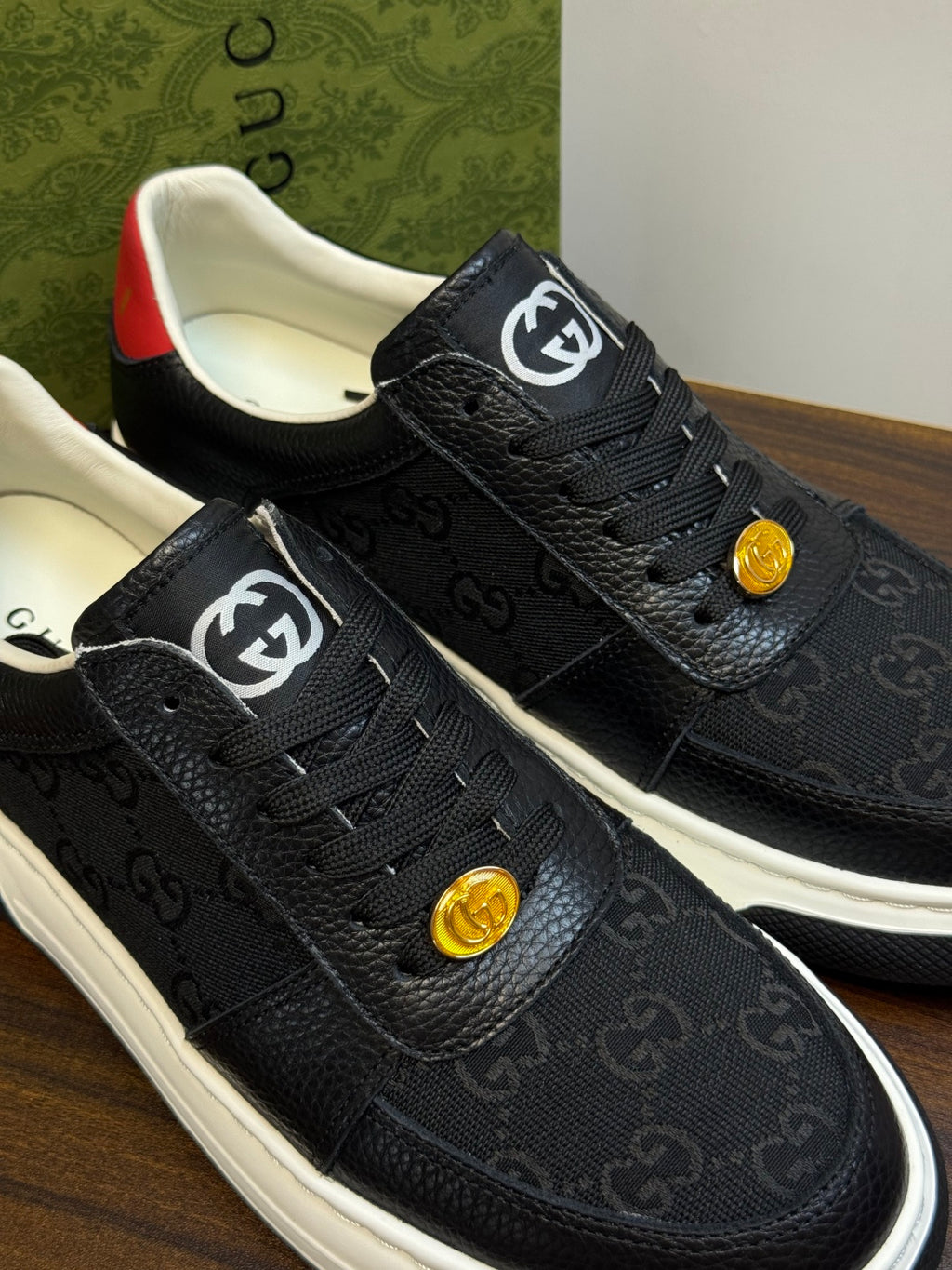 Gucci Ace Black GG Supreme Sneakers | Understated Style, Gold-Tone Accents & a Pop of Red
