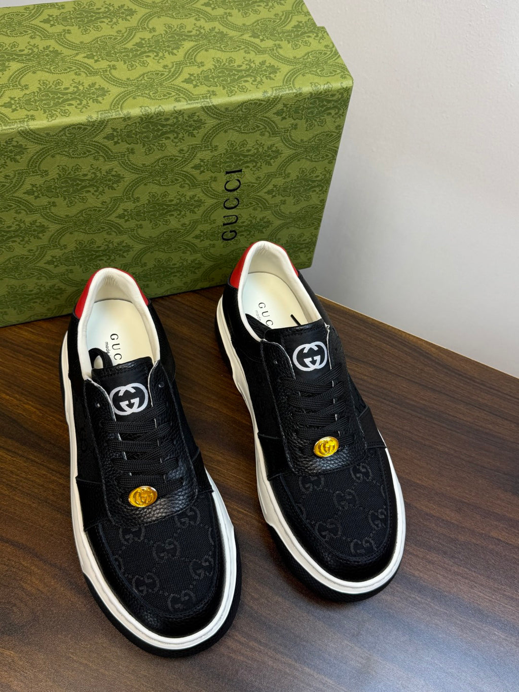 Gucci Ace Black GG Supreme Sneakers | Understated Style, Gold-Tone Accents & a Pop of Red