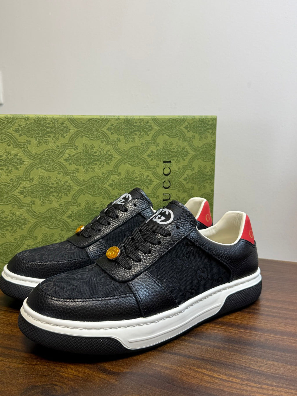 Gucci Ace Black GG Supreme Sneakers | Understated Style, Gold-Tone Accents & a Pop of Red