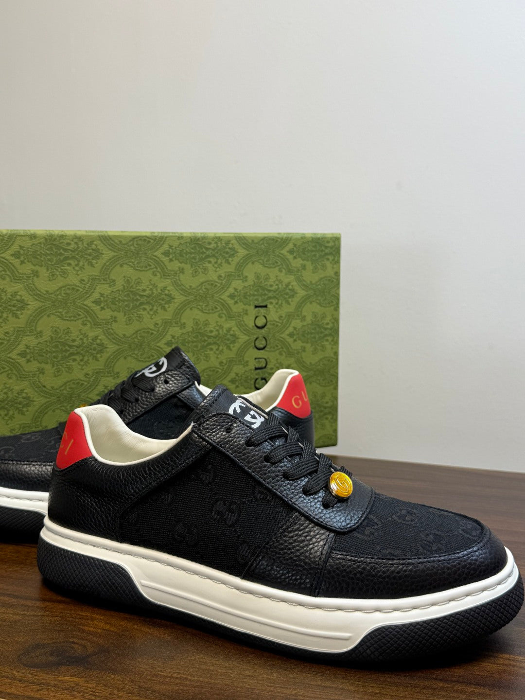Gucci Ace Black GG Supreme Sneakers | Understated Style, Gold-Tone Accents & a Pop of Red