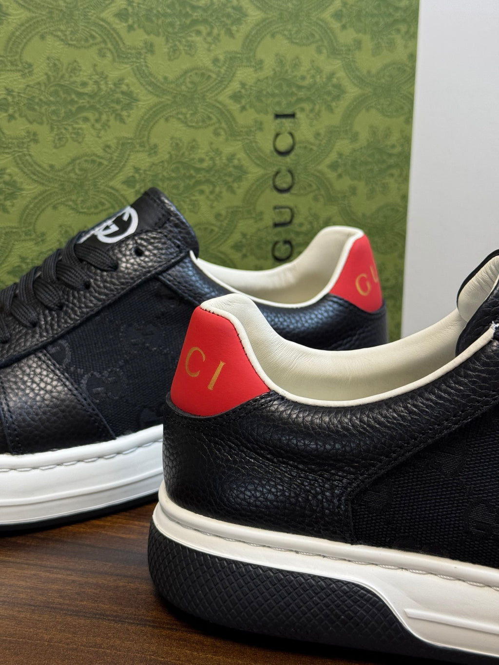 Gucci Ace Black GG Supreme Sneakers | Understated Style, Gold-Tone Accents & a Pop of Red