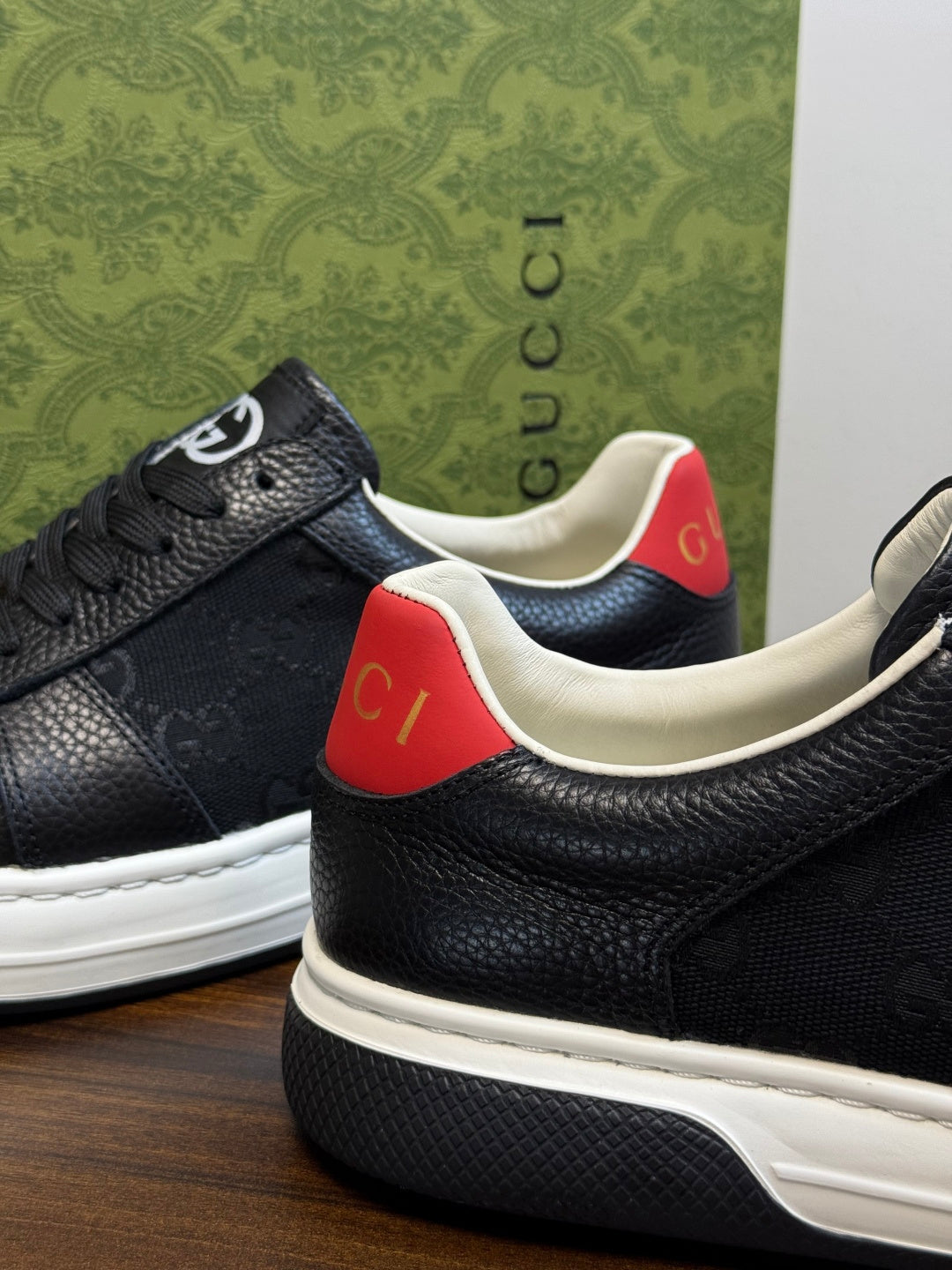 Gucci Ace Black GG Supreme Sneakers | Understated Style, Gold-Tone Accents & a Pop of Red