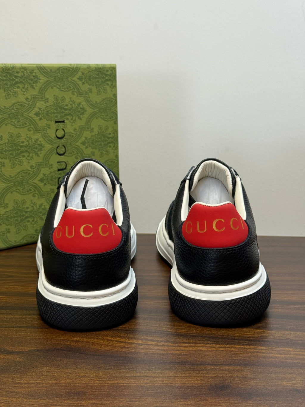 Gucci Ace Black GG Supreme Sneakers | Understated Style, Gold-Tone Accents & a Pop of Red