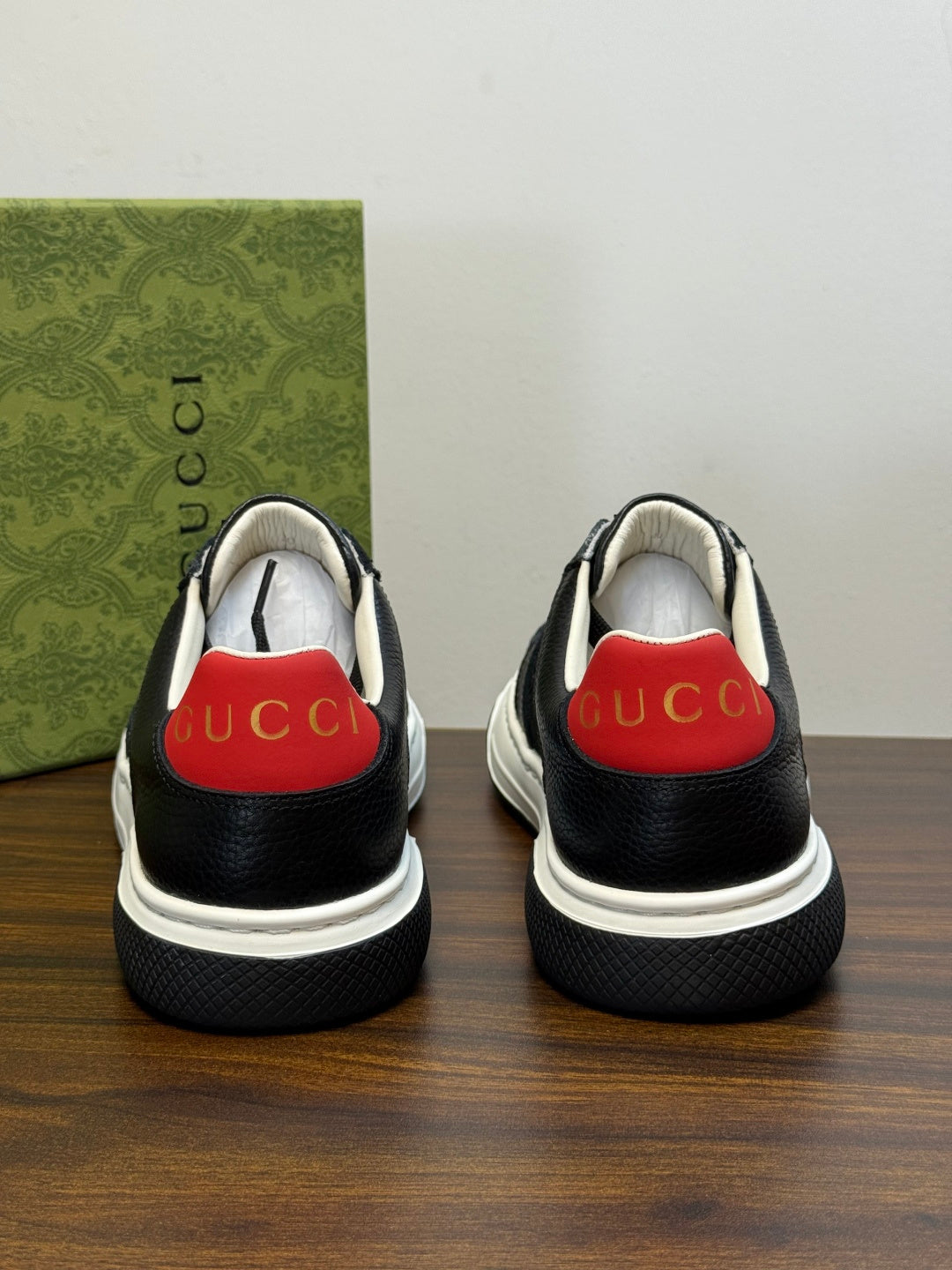 Gucci Ace Black GG Supreme Sneakers | Understated Style, Gold-Tone Accents & a Pop of Red