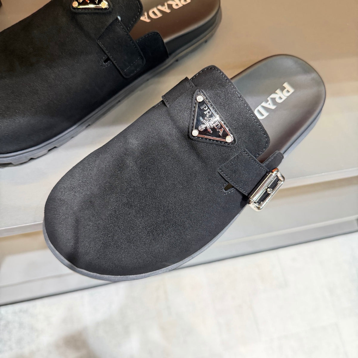 PRADA  Minimalist Black Mule Clogs | Metal Accents & Easy Slip-On Style