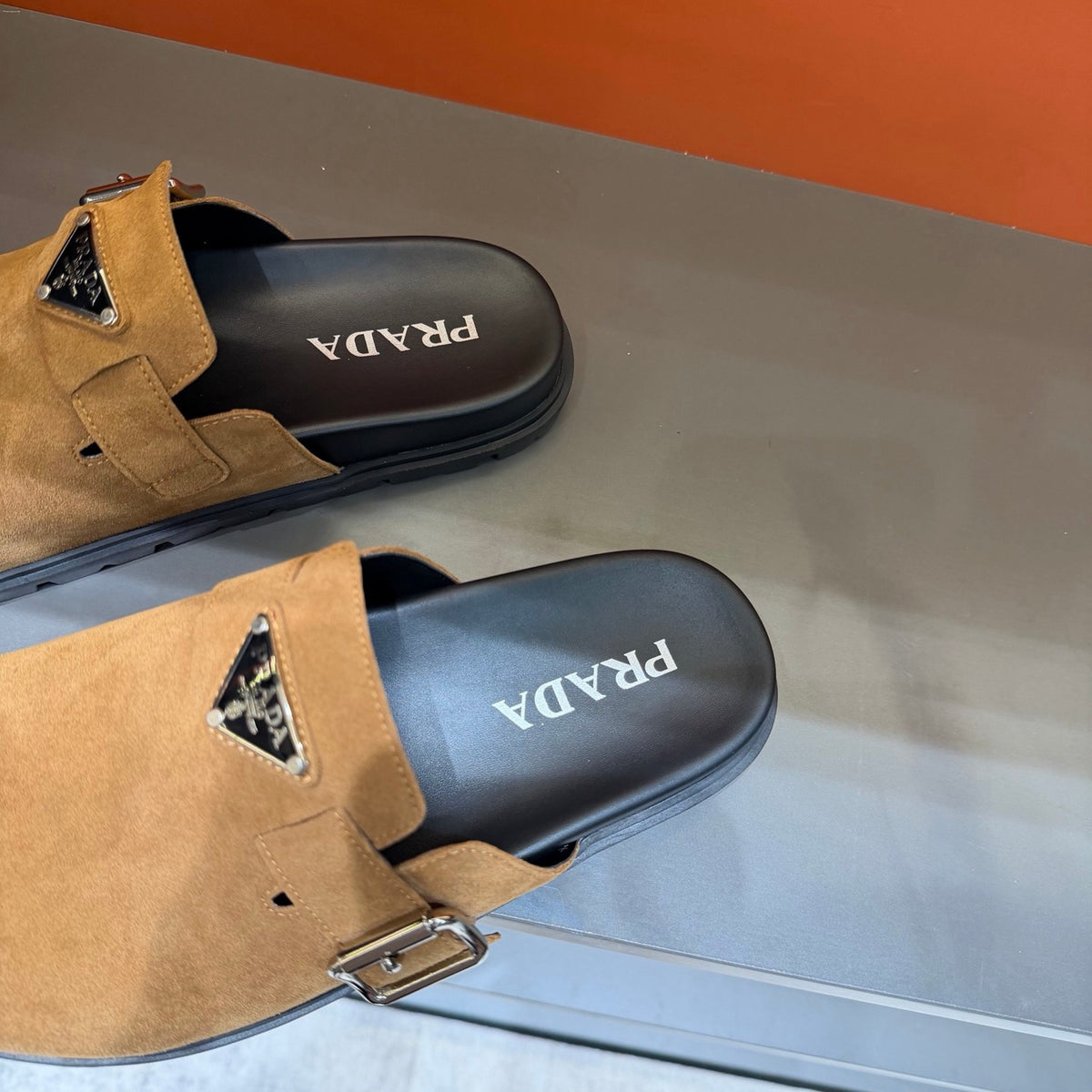 PRADA Men’s Camel Slip-On Mules | Triangle Logo & Metal Buckle Detail