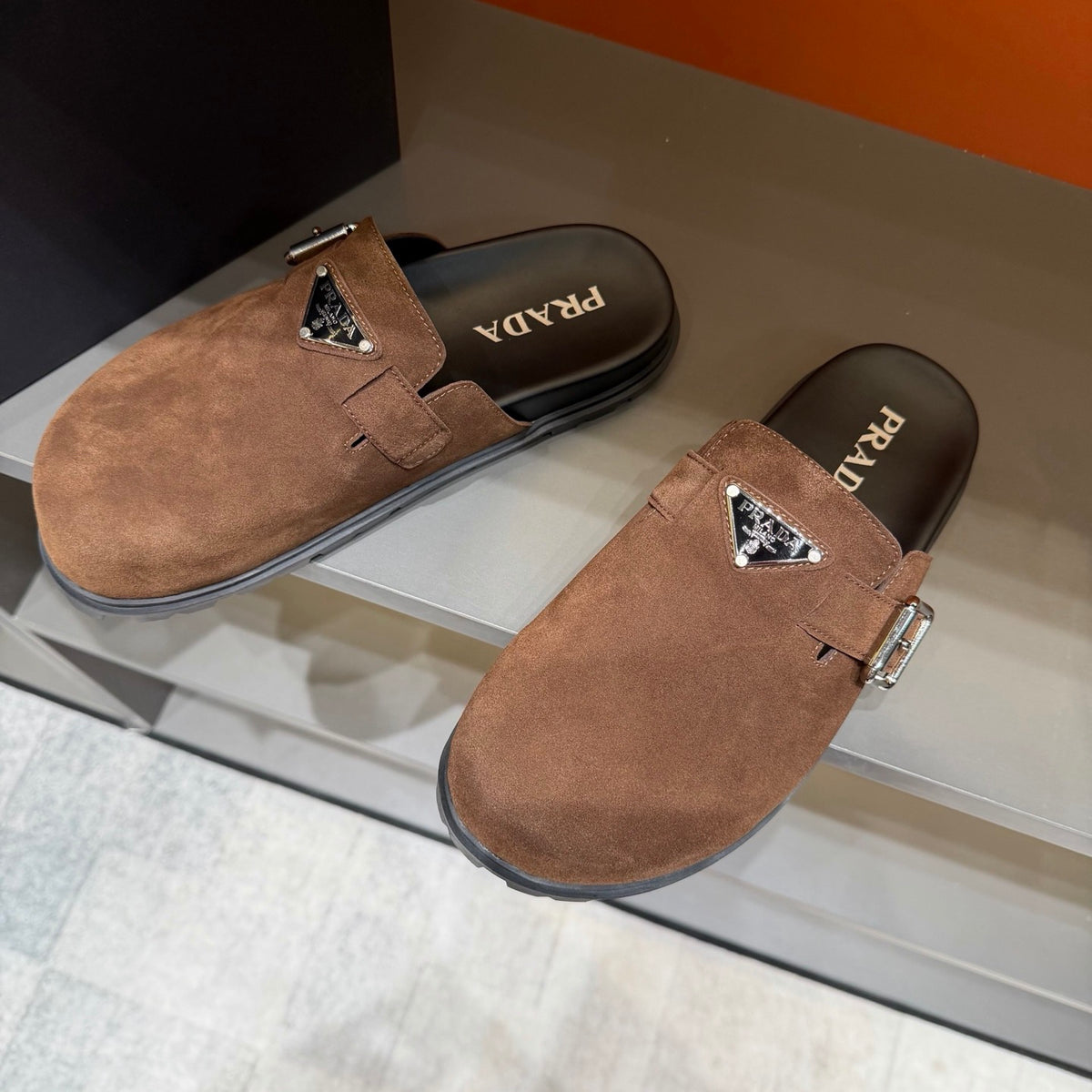 PRADA Men’s Warm Brown Mules | Triangle Logo & Metal Buckle Detail