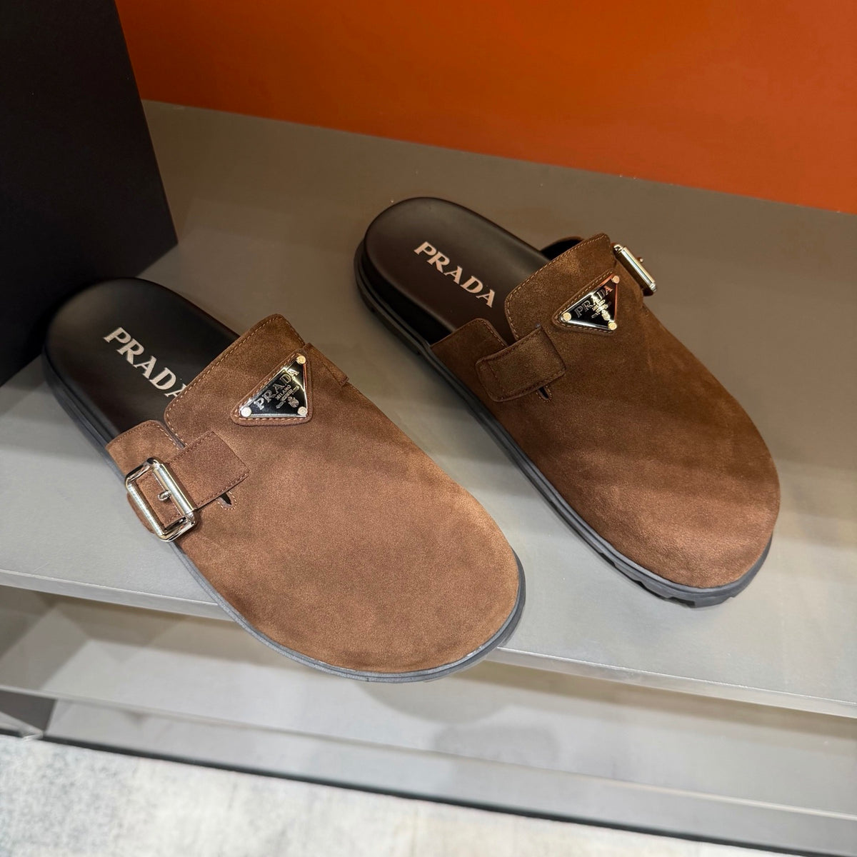 PRADA Men’s Warm Brown Mules | Triangle Logo & Metal Buckle Detail