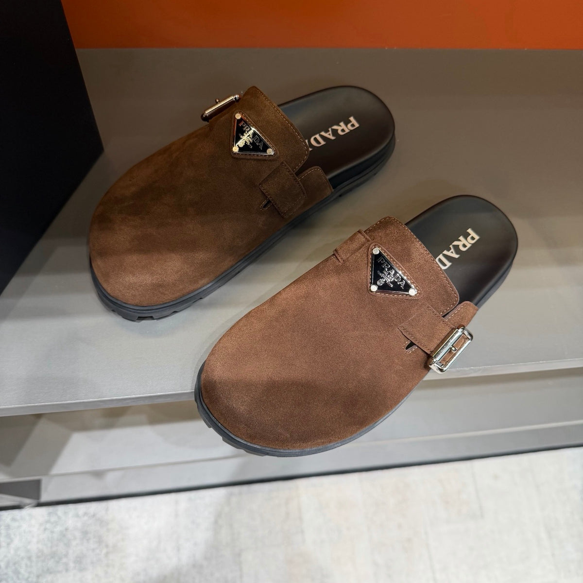 PRADA Men’s Warm Brown Mules | Triangle Logo & Metal Buckle Detail